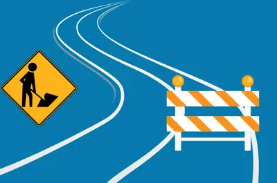 A road with construction signs.