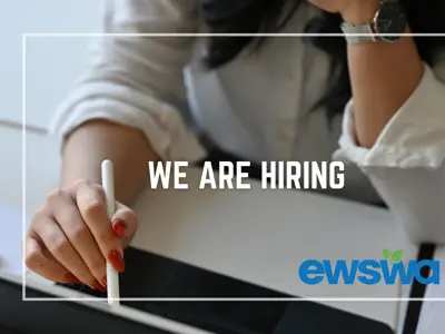 We are hiring. A worker in an office with a computer. The EWSWA logo.