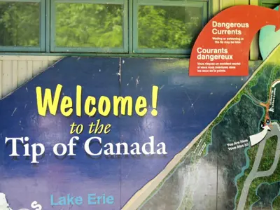 The welcome sign at the tip at Point Pelee National Park warns against swimming or even wading.