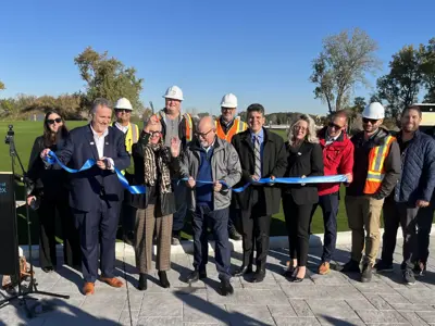 Warden Hilda MacDonald cuts a blue ribbon with colleagues at the roundabout at County Road 42 and County Road 43