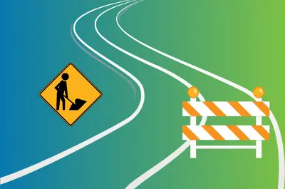 A road with construction signs.