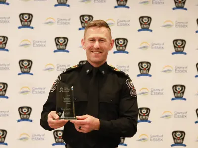 Essex-Windsor EMS Paramedic Gerry Seguin holds his award from Trillium Gift of Life