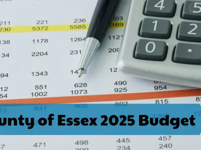 A close up view of a spreadsheet with numbers and a calculator and pen.