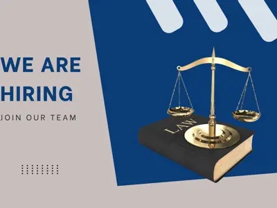 We are hiring. Join our team.  A law book and scales of justice.