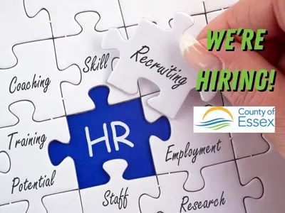 Fingers holding a puzzle piece that says recruiting above a puzzle with the words "We're Hiring" and the County of Essex logo.